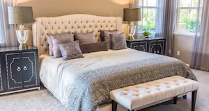 A plush silvery bed with many pillows