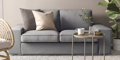 Simple and solid grey 2 seat sofa with low armrests and two neutral cushions